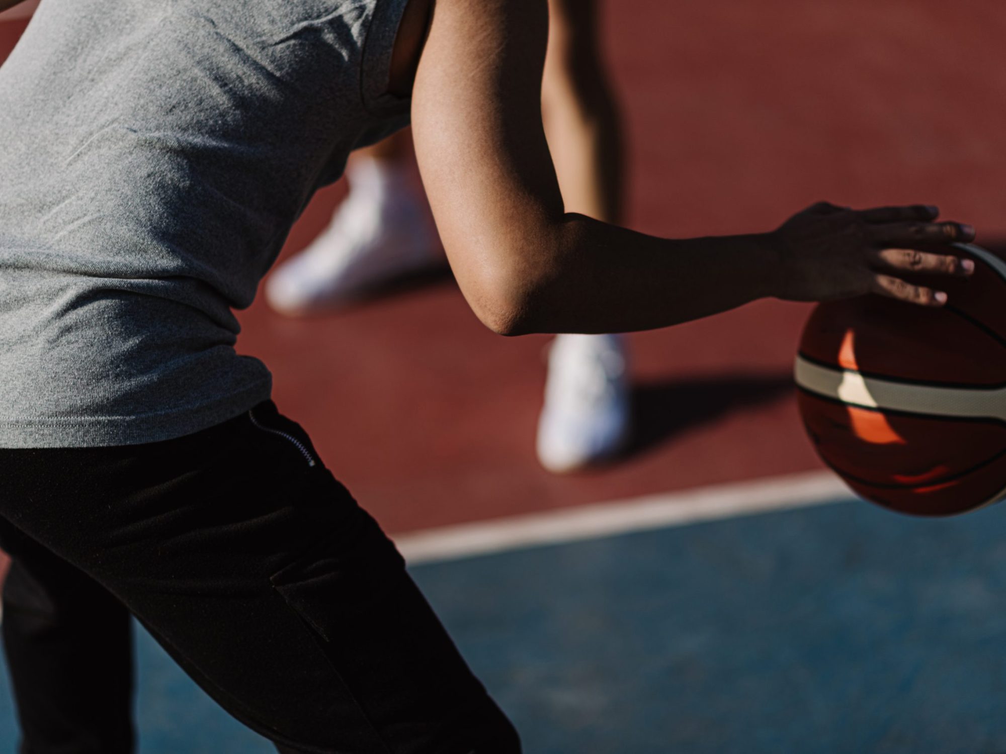 Sports and recreation concept two male basketball players enjoying playing basketball together on the sports ground.