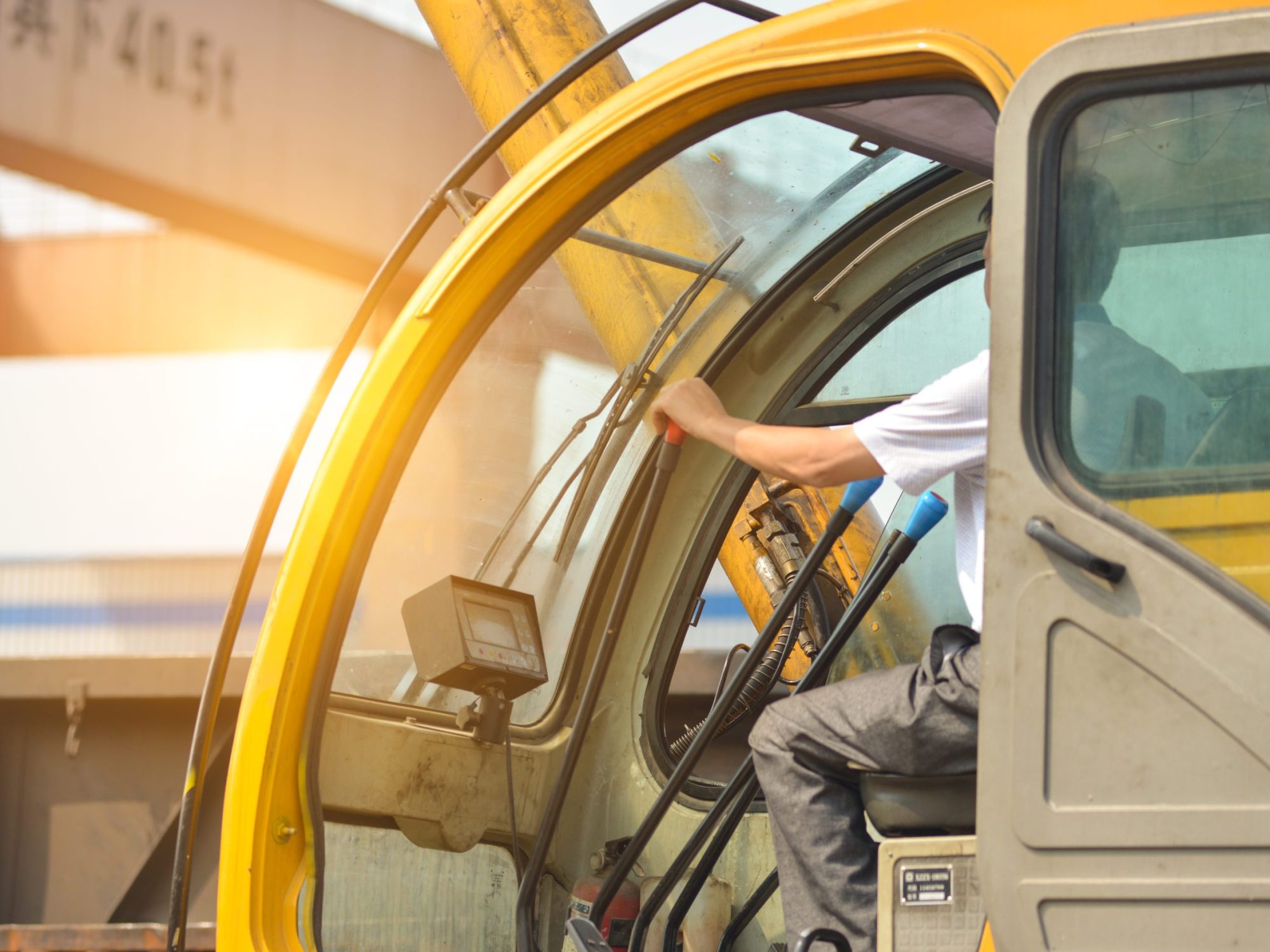 Man driving a crane to lift-up some equipments